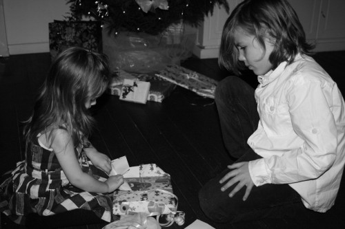 Opening presents on New Years eve, you wearing cotton printed dress and brother wearing white cotton shirt bu Hilde & Co and dark blue jeans by Diesel.